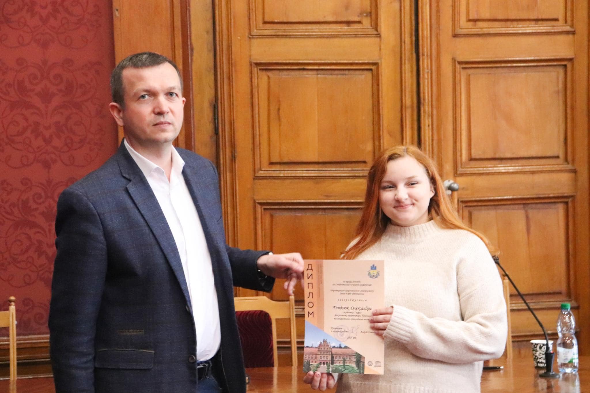 Модератор заходу, співголова оргкомітету – проректор з наукової роботи Андрій Саміла вручає диплом учасниці конференції